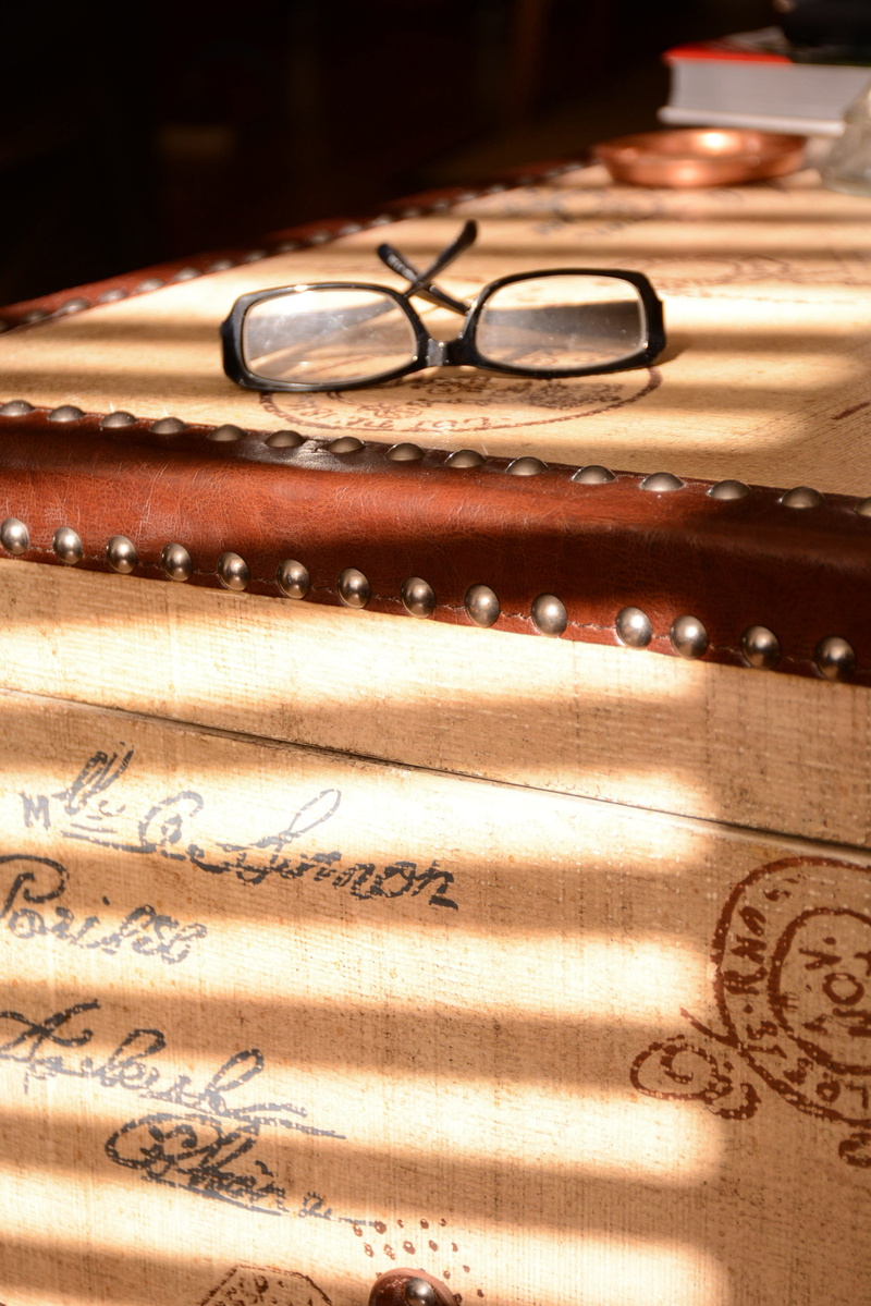 table, leather, text, leading lines, personal accessory, still life, eyeglasses, indoors, coaster, selective focus, wedding ring, focus on foreground, eyewear
