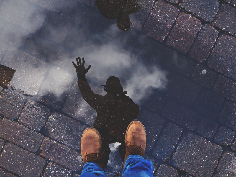 rain, men, uk, hand, reflection, shoe, camera, personal perspective, low section, standing, boot, floor, puddle, real people, day, street, portrait, paving stone