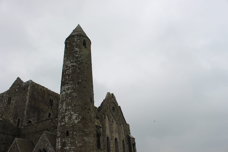 sky, tourism, built structure, low angle view, rock of cashel, architecture, history, ruin, old ruin, tower, cashel, building, outdoors, ruined, old, building exterior