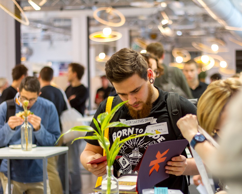 focus on foreground, young men, real people, women, study, event, plant, library, wireless technology, group, designer, facial hair, indoors, bokeh, holding
