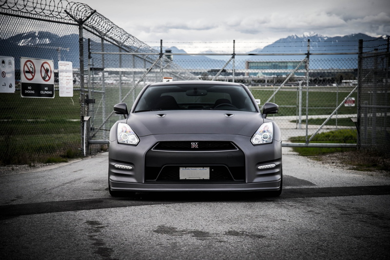 nature, building exterior, motor vehicle, matte black, built structure, mode of transportation, barbed wire, sky, land vehicle, GT-R, the front, day, car
