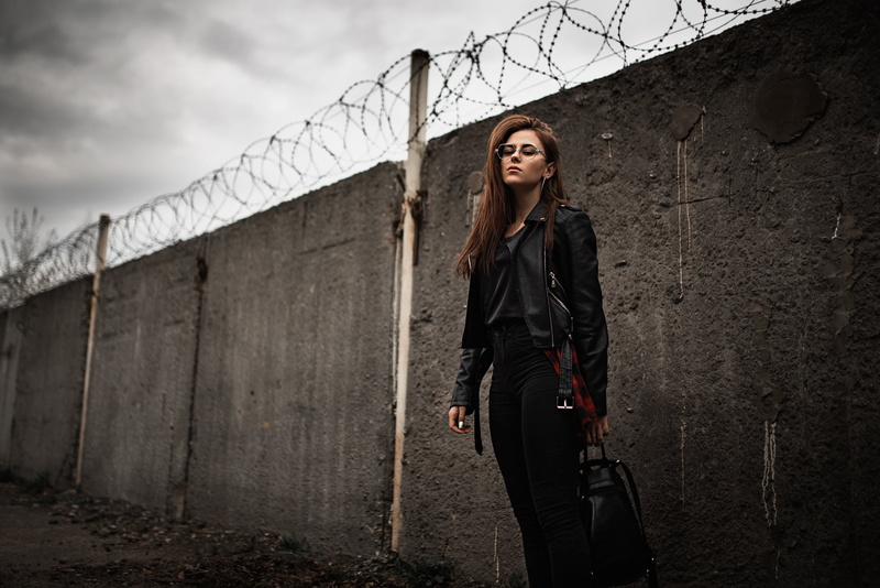 long hair, leather jackets, black clothing, brunette, Ilya Baranov, model, barbed wire, wall, women outdoors, women, backpacks, black jackets, standing