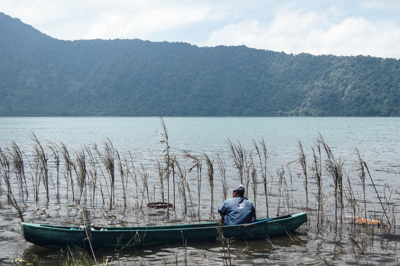 water, non-urban scene, rowboat, scenics - nature, bedugul, sitting, denpasar timur, transportation, casual clothing, reed, lake beratan temple tour, mountain