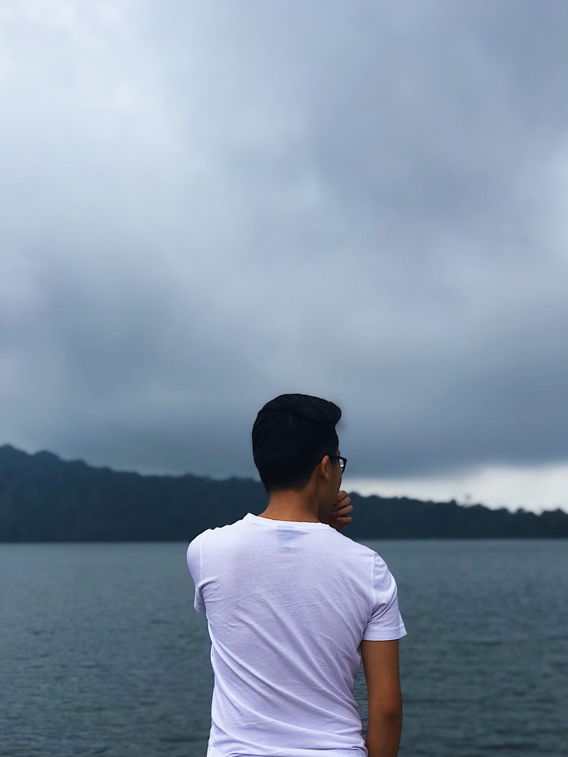 water, tranquility, indonesia, lifestyles, young adult, danau beratan bedugul, beauty in nature, looking at view, sky, rear view, young men, nature, real people
