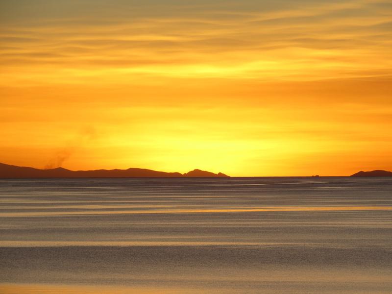 non-urban scene, salt flat, water, outdoors, sky, sunset, yellow, cloud - sky, no people, environment, idyllic, romantic sky, silhouette, lake titicaca