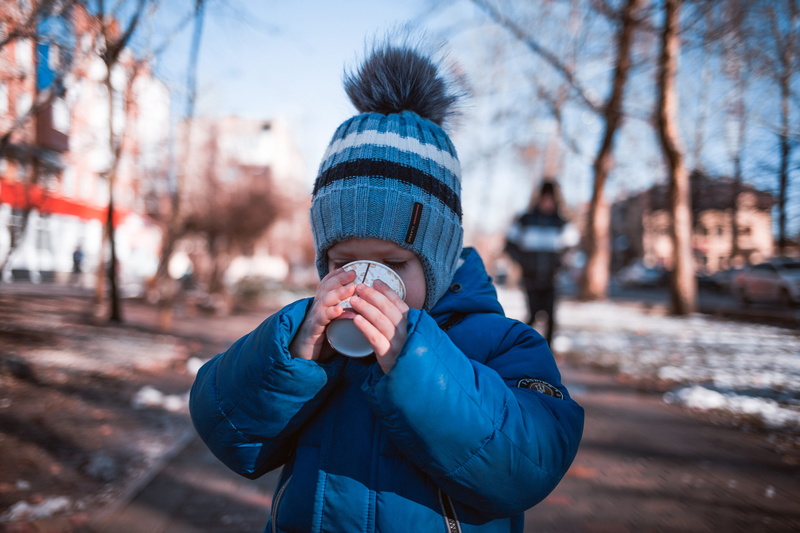 5K, leisure activity, beverage, boy, apparel, hood, front view, bonnet, drinking, obscured face, coat, focus on foreground, white, cup, human, lifestyles