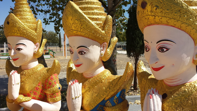 clothing, sunlight, art and craft, buddhist, outdoors, gold colored, disguise, no people, human representation, carnival - celebration event, representation