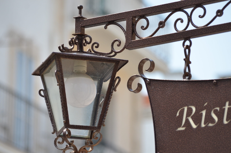 old, lamp, sign, alberobello, architecture, low angle view, focus on foreground, outdoors, communication, text, pattern, wrought iron, hanging, metal, lighting equipment