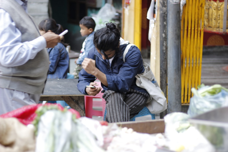 bending, crash helmet, women, three quarter length, holding, standing, human, tire, person, plastic bag, bag, plastic, apparel, people, undershirt, incidental people