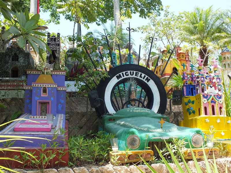 arts culture and entertainment, tropical climate, no people, car, building exterior, growth, plant, park - man made space, day, multi colored, tree, creativity