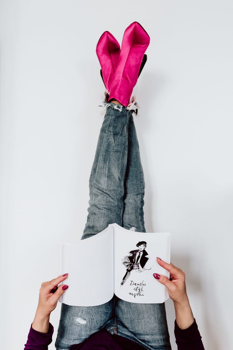 lifestyles, text, boots, paper, blues jeans, wall - building feature, obscured face, indoors, studio shot, one person, pink, casual clothing, real people
