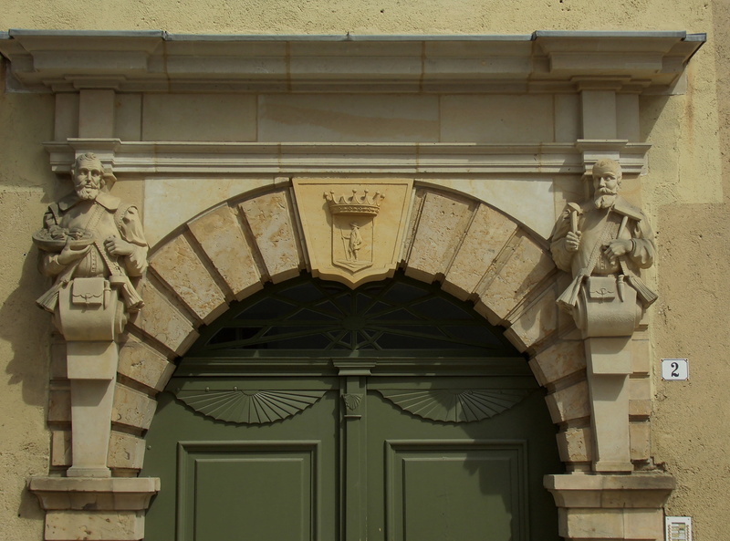 low angle view, closed, built structure, no people, entrance, outdoors, saxony, day, architecture, mountain town, the past, arch, carving - craft product