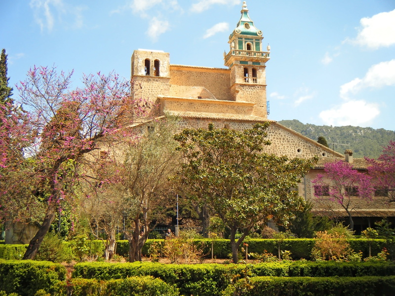 monastery, garden, built structure, day, valdemossa, spire, spain, tree, alley, park, growth, building, houses, mountains, sky, architecture, tour, the stones