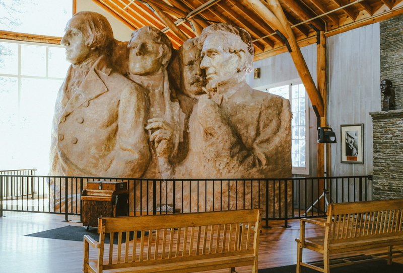 railing, low angle view, history, female likeness, creativity, inside, craft, representation, indoors, travel destinations, building, day, chair, united states