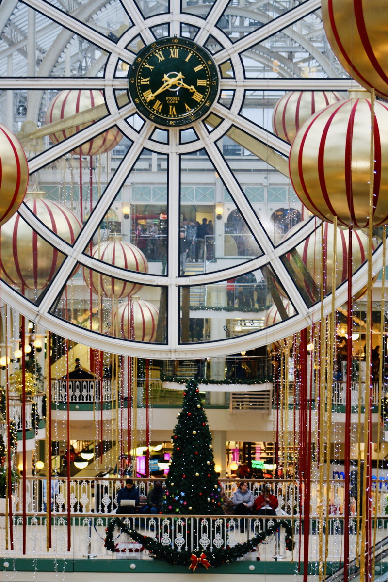 outdoors, christmas decoration, clock, art and craft, festive, representation, ceiling, glass - material, amusement park ride, city, colorful, travel, building exterior