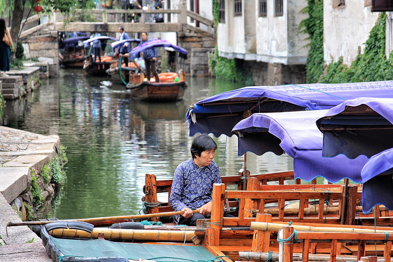 umbrella, lifestyles, incidental people, chinese culture, village, rain, architecture, mode of transportation, zhouzhuang ancient town, sitting, women