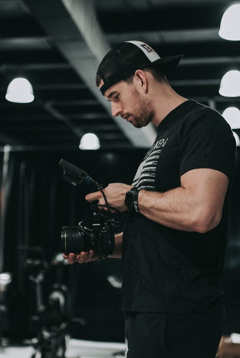 person, indoor, photography themes, hat, real people, young men, music, entertainment occupation, film, side view, steady, moody, camera, skill, dslr, arts culture and entertainment