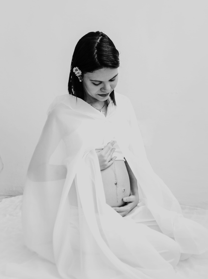 furniture, wedding, momtobe, beautiful woman, sleeve, front view, womb, looking down, white, lifestyles, holding, young adult, wedding gown, mom, women