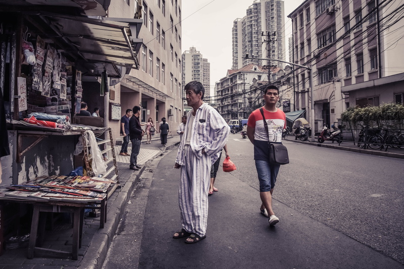 magazine, casual clothing, street, building, real people, day, building exterior, outdoors, standing, people, architecture, man, pyjama, full length, sleepwear