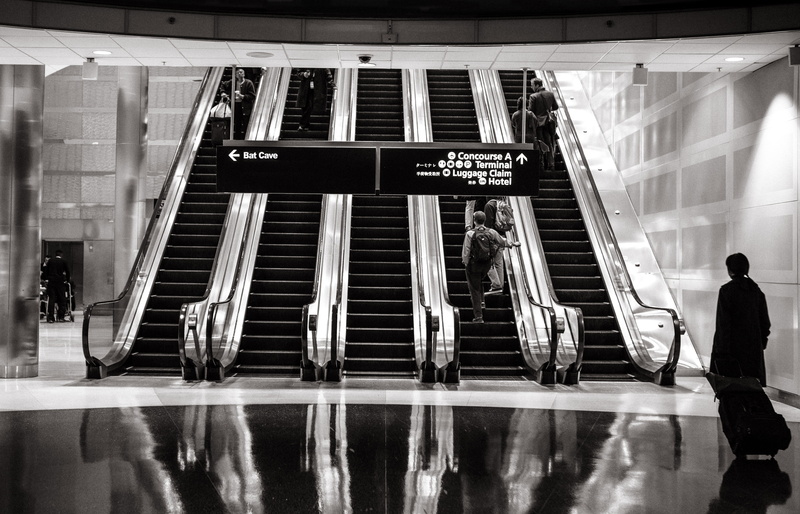 stairs, sign, stair, public transportation, architecture, full length, train station, people, western script, mode of transportation, flooring, woman, walking