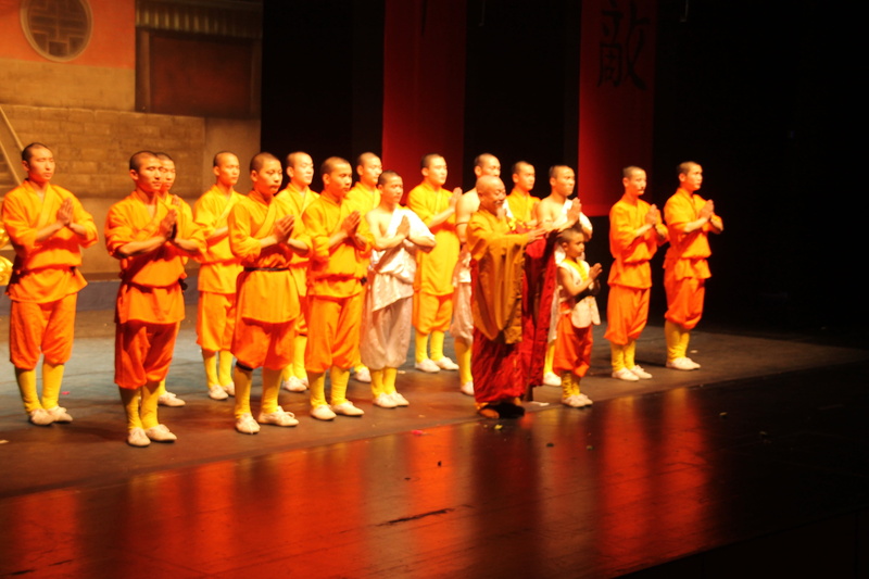 indoors, occupation, stage, women, standing, males, child, teamwork, monks, skill, men, shaolin, large group of people, real people, stage - performance space