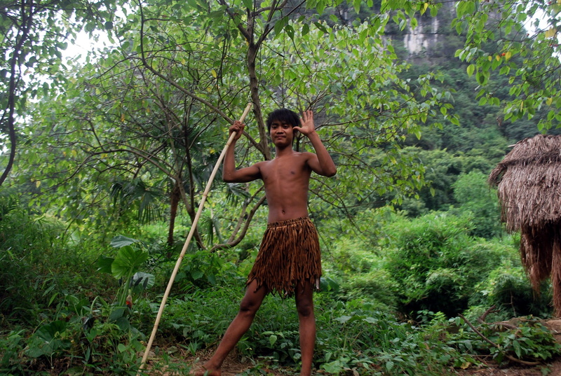 waving, real people, chinese, land, males, children only, semi-dress, day, tree, 2K, ethnic, wear, growth, front view, hut, Ethnic, wielding, greenery