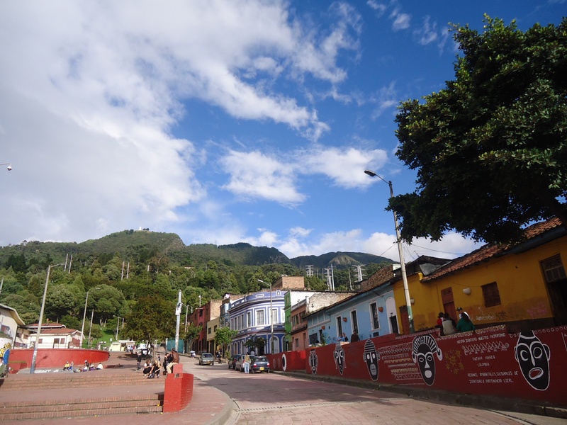 quevedo jet, built structure, land vehicle, incidental people, motor vehicle, residential district, bogota, car, cloud - sky, colombia, plant, city, street
