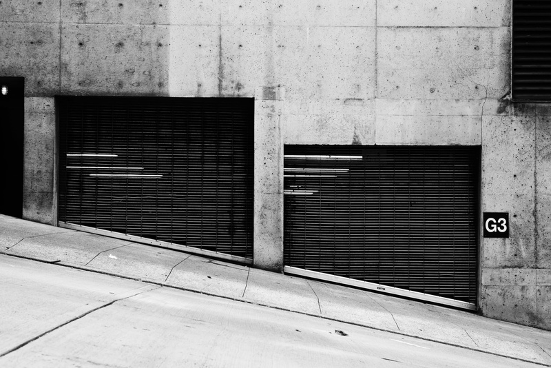 shutter, wall - building feature, protection, urban Scene, g, city, pavement, parking garage, black metal, closed, sidewalk, wall, footpath, urban, abandoned