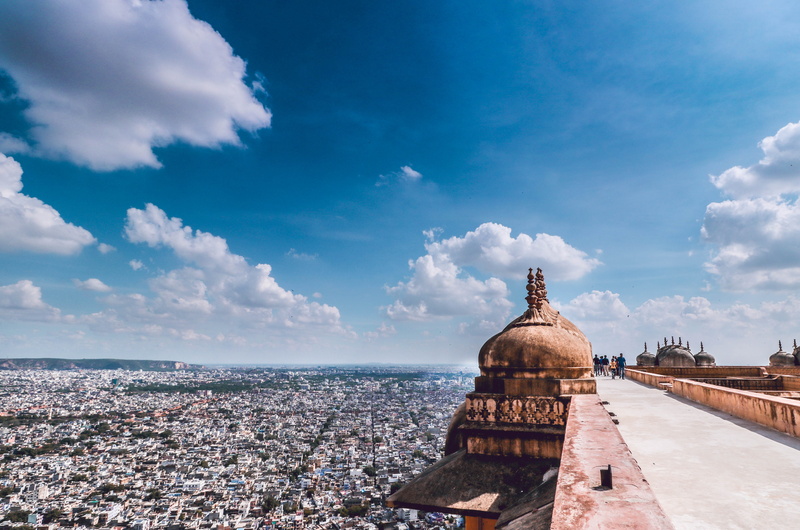 religion, architecture, palace, people, day, city, fort, cityscape, travel, place of worship, sky, spirituality, horizon, history, jaipur, building exterior