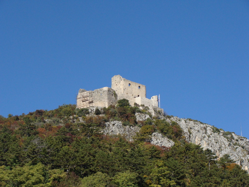mountain, blue, fortress, low angle view, historic, outdoors, built structure, building exterior, ancient, fort, sky, travel destinations, the past, stone