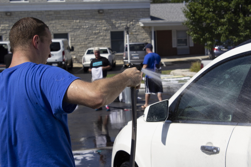 adult, occupation, spraying, outdoors, cleaning, mode of transportation, land vehicle, blue, day, united states, people, holding, men, water, focus on foreground