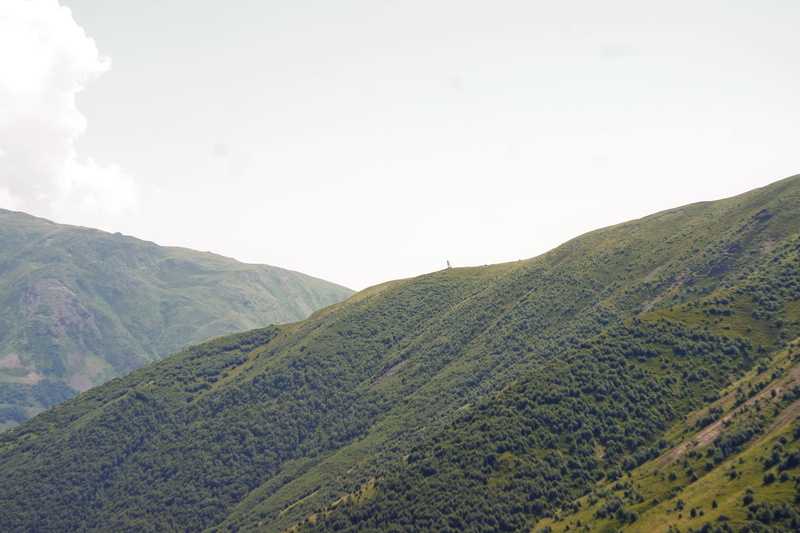 no people, non-urban scene, mountain range, green color, sky, land, cloud - sky, tranquil scene, outdoors, rolling landscape, stepantsminda, environment