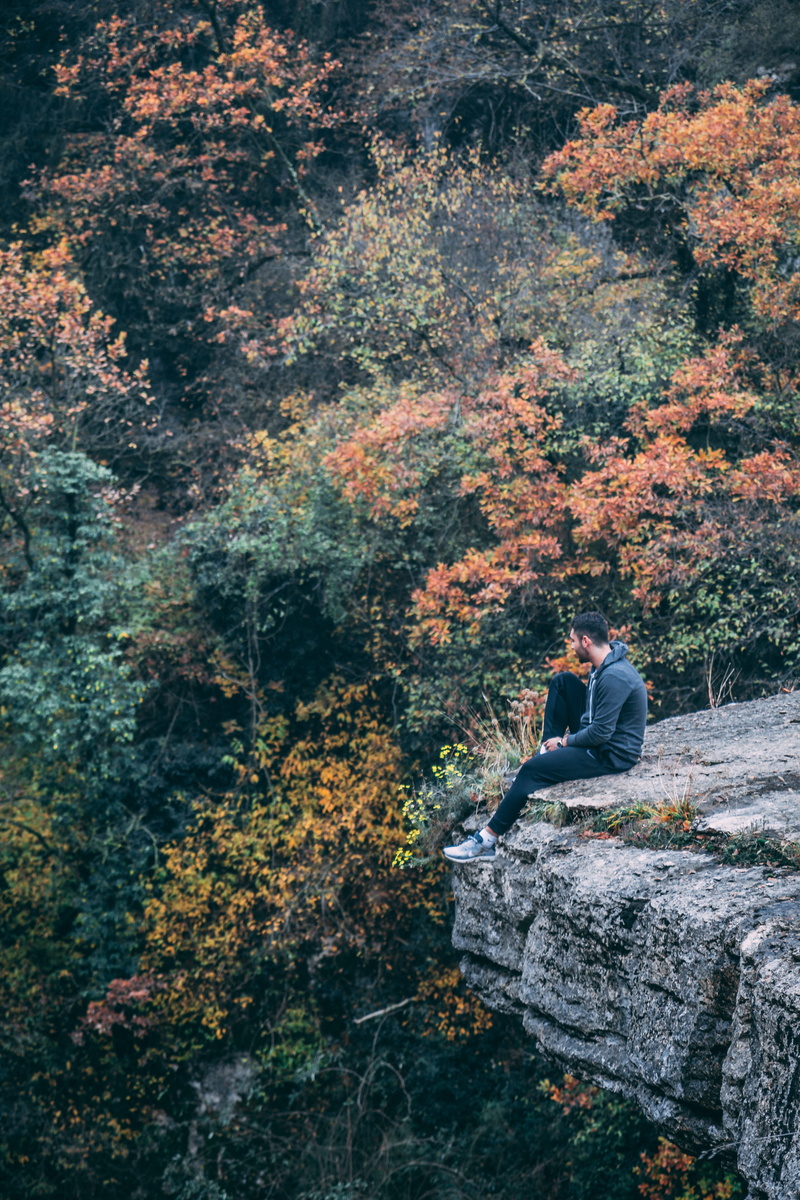 full length, one person, landscape, photography, environment, day, explorer, fall, 5K, black, outdoors, tree, sitting, rock, autumn, autumn leaves, change
