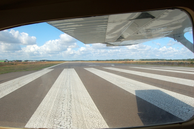 aircraft, flight, concrete, sunlight, symbol, mode of transportation, travel, asphalt, airplane, marking, aviation, cloud - sky, airport, air vehicle, sky