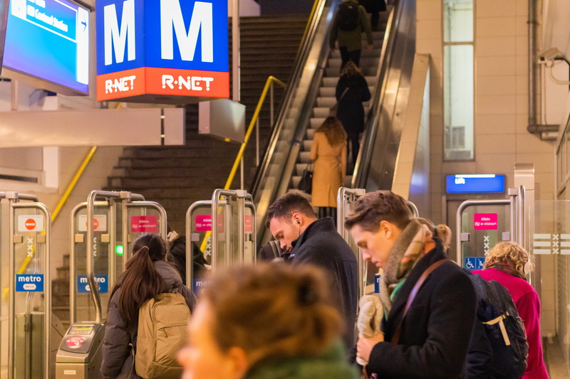 warm clothing, illuminated, women, mode of transportation, transportation, overcoat, lcd screen, apparel, person, subway train, clothing, architecture