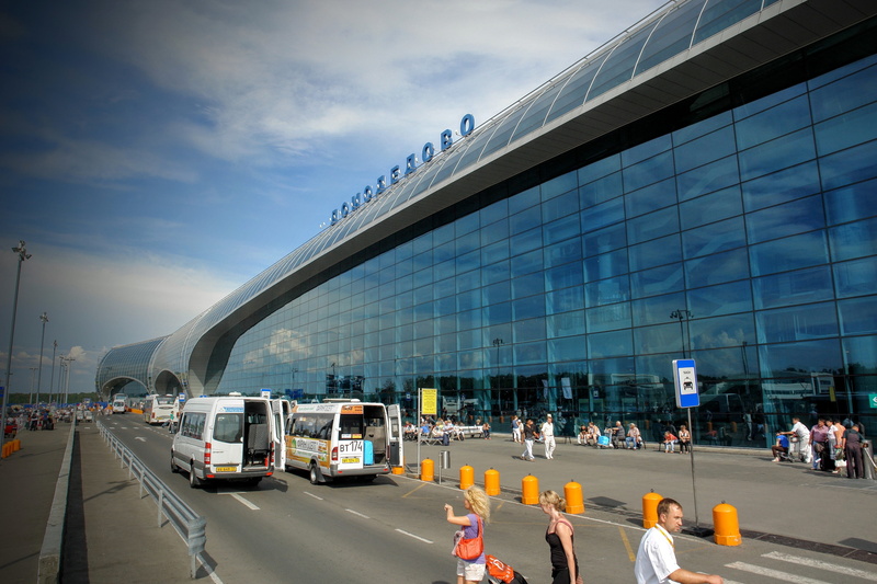 architecture, building, transportation, travel destinations, day, outdoors, mode of transportation, group of people, airport, motor vehicle, domodedovo