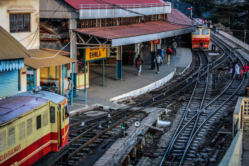 railroad station platform, transportation, outdoors, railway, railroad station, famous, train, tourism, group of people, railroad track, building exterior