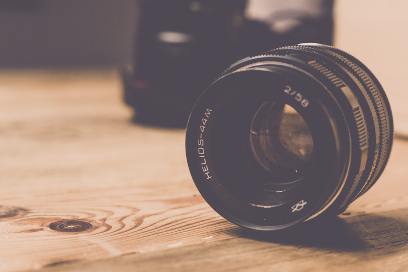 indoors, focus on foreground, wood - material, black, still life, 5K, retro styled, table, camera - photographic equipment, lens, photographic equipment