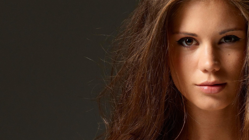 looking at camera, long hair, human hair, body part, brown hair, young adult, one person, human body part, adult, studio shot, hair, serious, beautiful woman