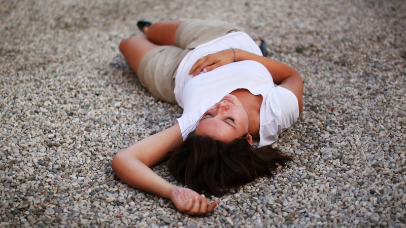 one person, outdoors, relaxation, young adult, child, females, young women, leisure activity, land, lying down, real people, smiling, day, casual clothing