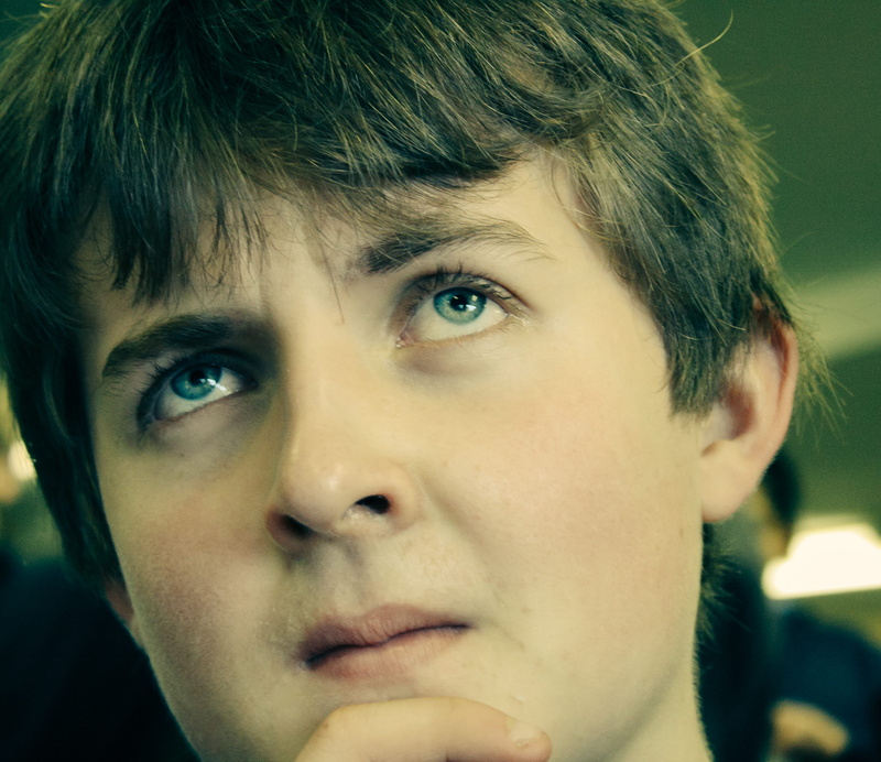 teenager, contemplation, one person, looking at camera, blue, hmm, lifestyles, headshot, white, front view, cream, face, indoors, orange, expression, blue eyes