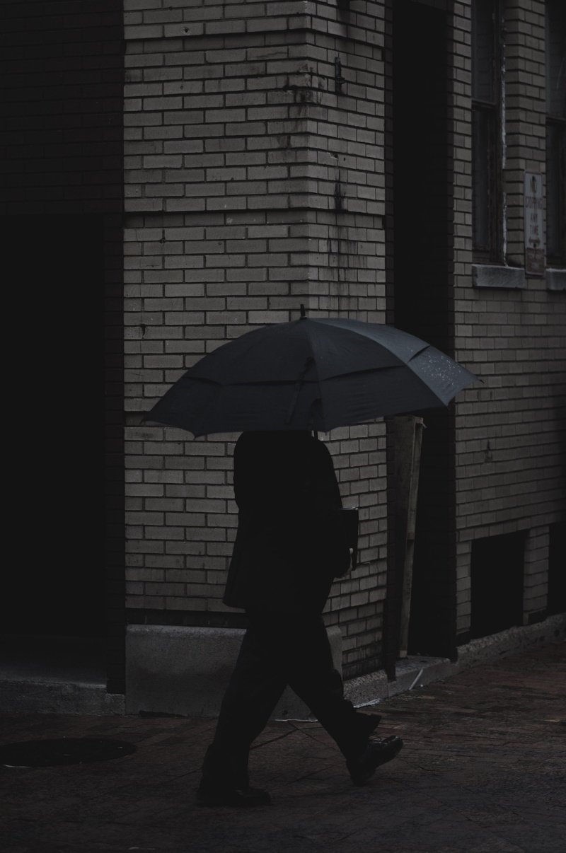 man, one person, lifestyles, real people, street, built structure, sheltering, protection, rainy season, architecture, pavement, women, building exterior