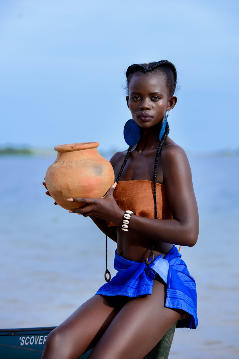 boat, standing, brown, girl, looking at camera, beach, vacation, childhood, earrings, braided hair, model, leisure activity, clay, holding, leisure, blue