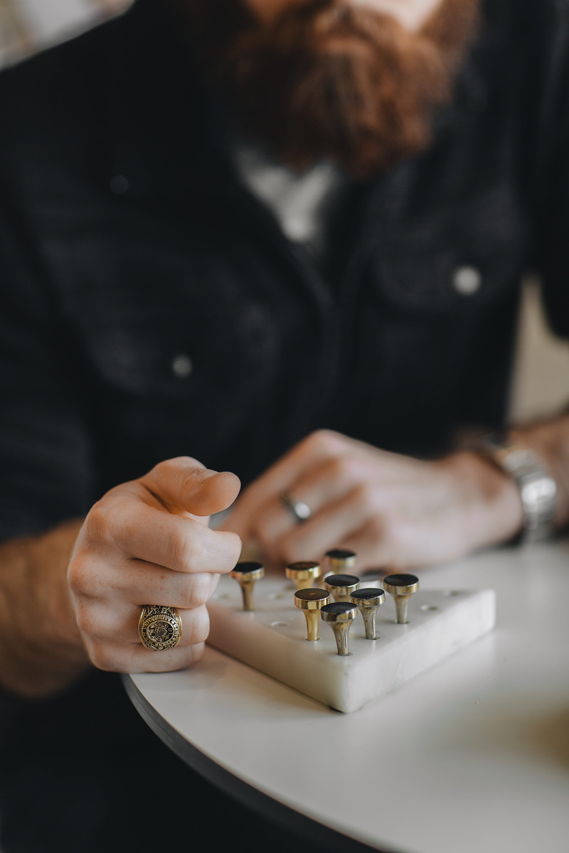 near, men, table, midsection, indoors, selective focus, human hand, taper, desk, ring, real people, looking, beard, signet, tool, holding, wearing, human body part