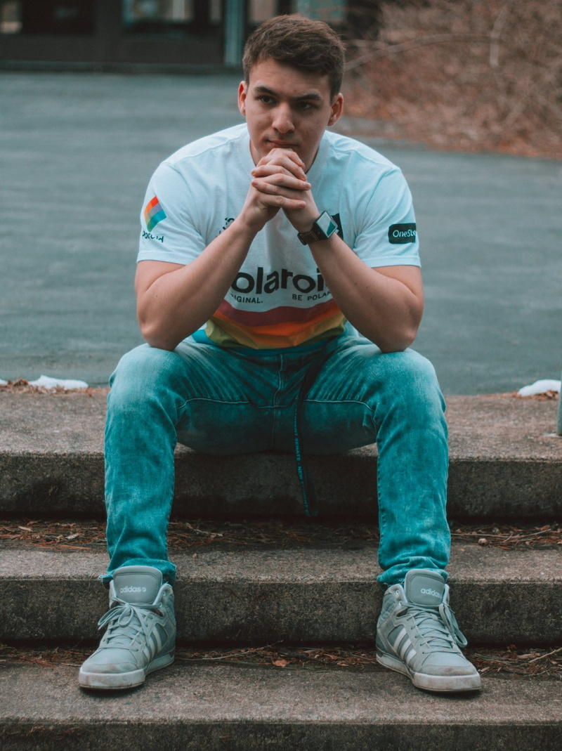 jeans, outfit, polaroidpacsun, sitting, young men, day, fade, 2K, full length, muscular, contemplation, skinny jeans, haircut, men, one person, muscle