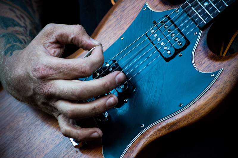wood - material, sg, string instrument, plucking an instrument, artist, occupation, musician, playing, hand, rock music, musical instrument string, arts culture and entertainment