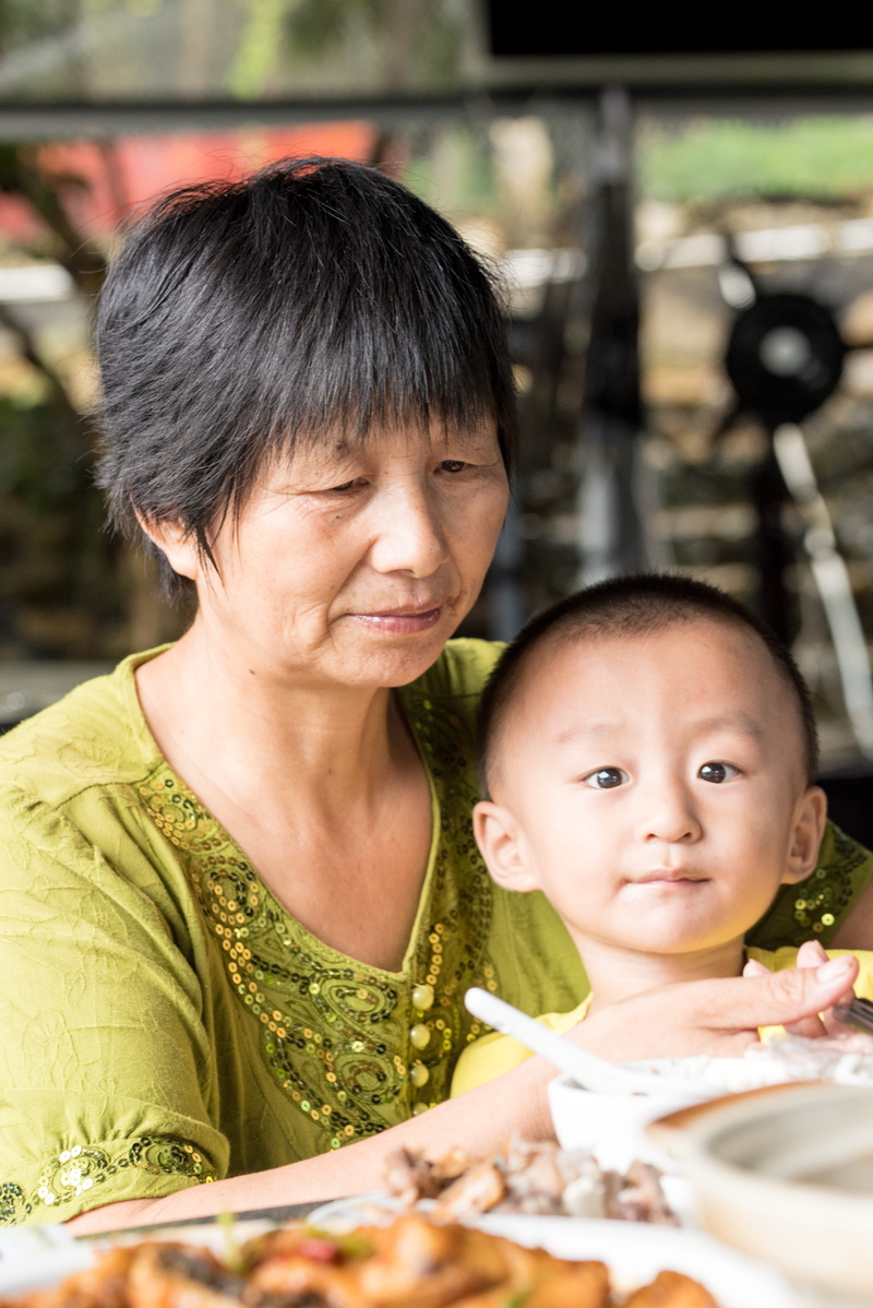 front view, real people, two people, grandmother, togetherness, adult, grandson, lifestyles, emotion, headshot, grandchild, people, woman, green, women