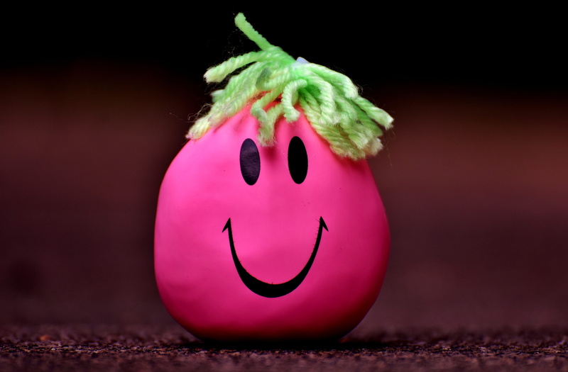 smiley, green, no People, single object, focus on foreground, funny, smiley face, food, anthropomorphic smiley face, creativity, decoration, brown, black background