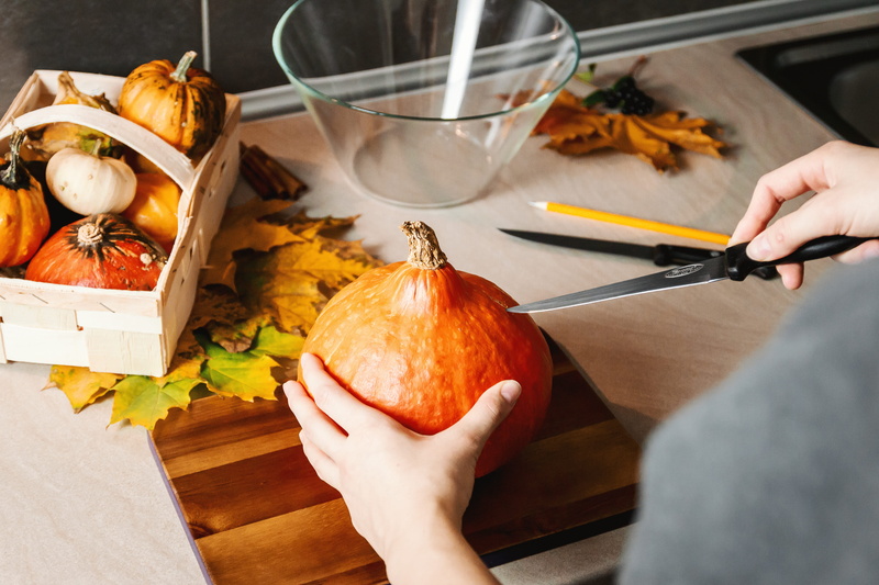 indoors, halloween, girls, celebration, carve, wellbeing, 4K, table, one person, vegetable, high angle view, hand, preparing food, human body part, women