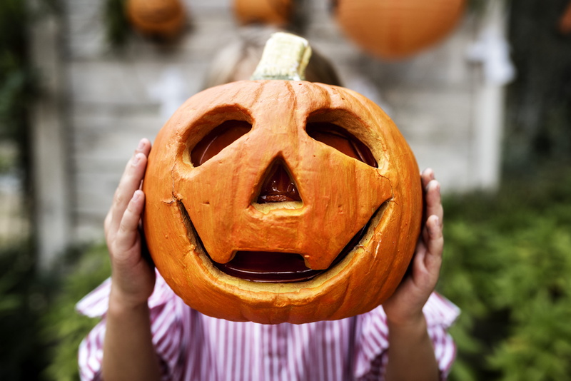 one person, wear, obscured face, anthropomorphic, day, public domain images, sculpture, handmade, celebration, person, outdoors, focus on foreground, halloween pumpkin
